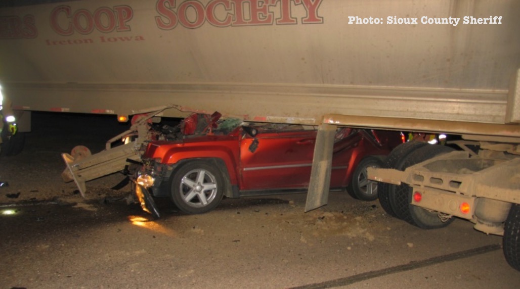 Woman requires extracation from SUV after crashing into feed trailer